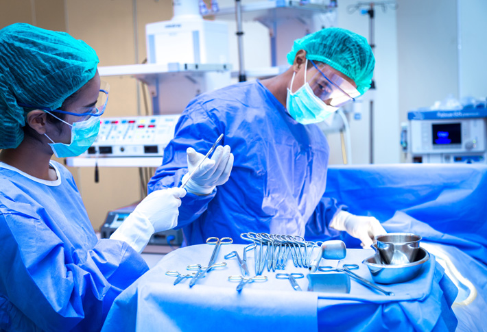 Surgeons preparing medical tools for an operation